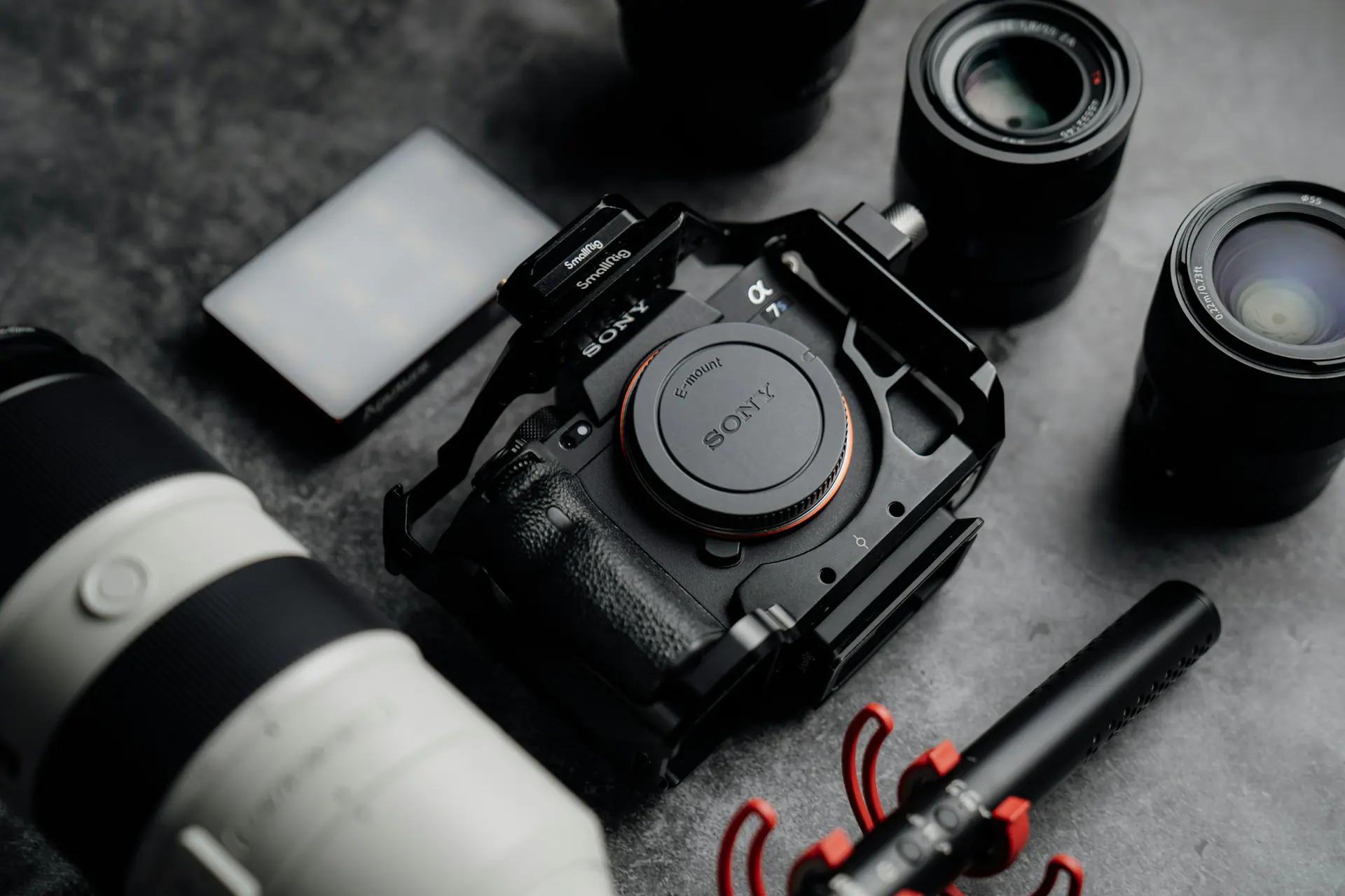 Camera body, lens and notepad arranged on a table for a content shoot