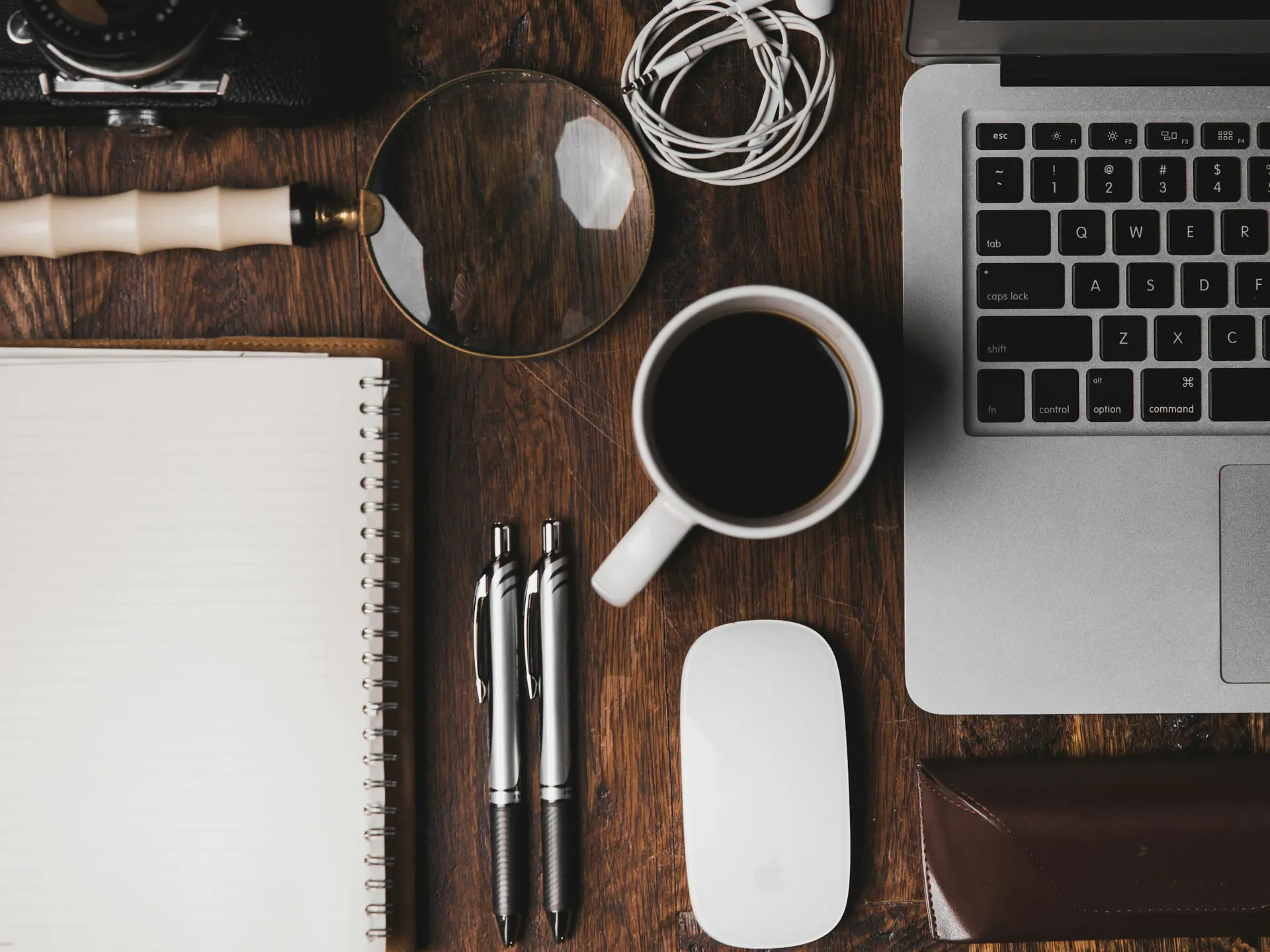 Cup of coffee beside a laptop on a light content-planning desk
